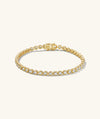 Zadie Bezel Lab Grown Sapphire Tennis Bracelet featuring gold design with diamond accents, showcasing its elegant bezel setting and sophisticated appeal.