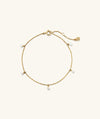 Ama Pearl Bracelet: A delicate gold chain bracelet adorned with miniature freshwater pearls, perfect for adding a summer touch to any outfit.