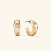 Dôme Hoops: A pair of classic gold hoop earrings, perfect for stacking with daintier rings to create a stylish, bold look.